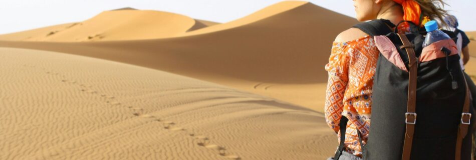 woman riding animal on dessert