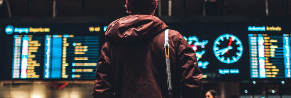 person looking up to the flight schedules