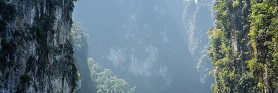 white boat in between rocky mountains